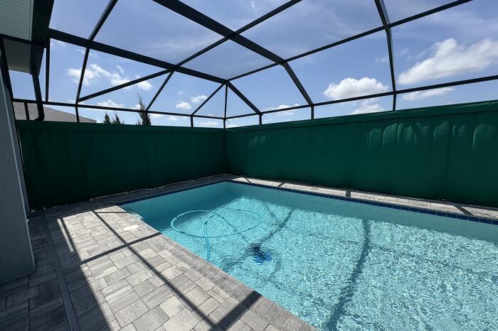 Lakefront screened pool in Viera, FL on weekly pool service